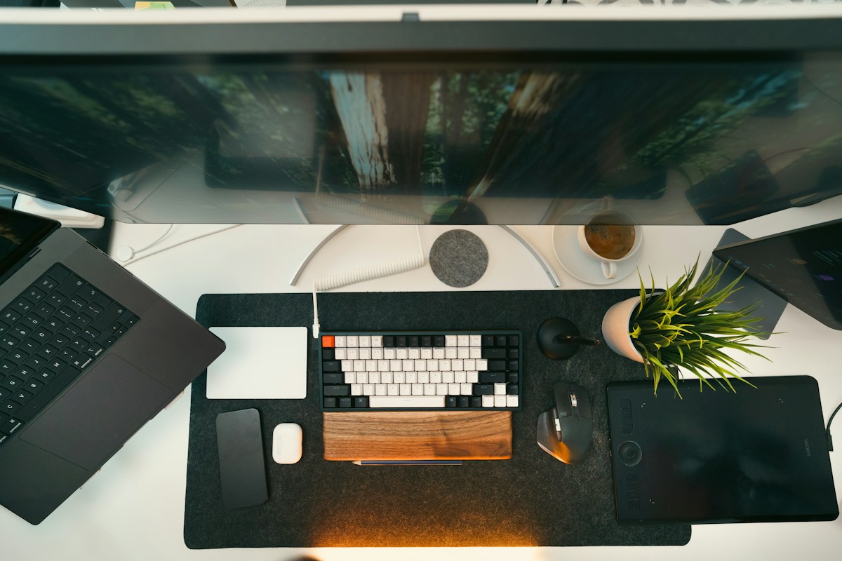 A modern workspace with a laptop and dual monitors